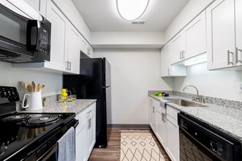 Fully equipped kitchen includes frost-free refrigerator, electric range, & dishwasher